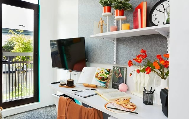 Desk with TV books plants and coffee study area at Scape Darlington in Sydney Student Accommodation