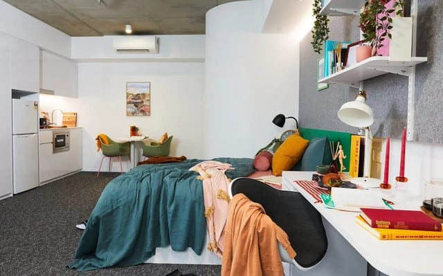 Bed kitchen table chairs and desk Bedroom at Scape Darlington in Sydney Student Accommodation
