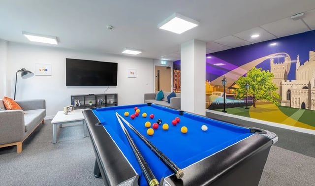 Pool table sofa and wall art common area at Central Living in Exeter Student Accommodation