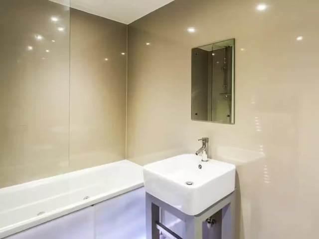 Modern bathtub sink and mirror bathroom at 42 Watford Street in Stoke-On-Trent Student Accommodation