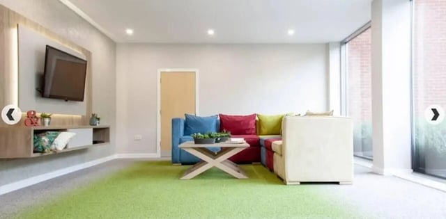 TV wall unit sectional sofa coffee table living room at Denmark Road in Manchester Student Accommodation