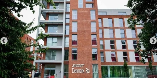 Red brick building with many windows exterior at Denmark Road in Manchester Student Accommodation
