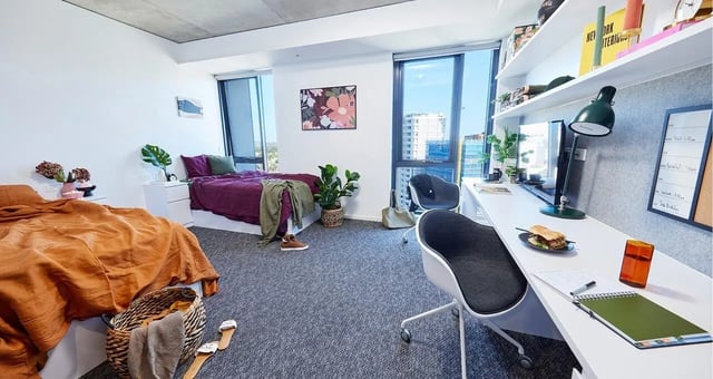 Two beds desk and chairs bedroom at Scape Redfern in Sydney Student Accommodation