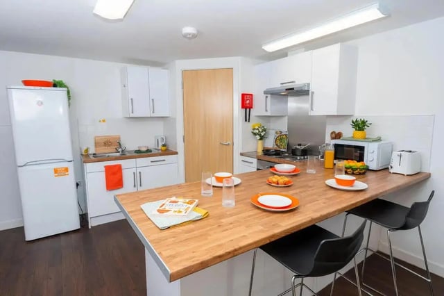 Refrigerator sink cabinets toaster microwave kitchen island kitchen at Grafton Street in Manchester Student Accommodation