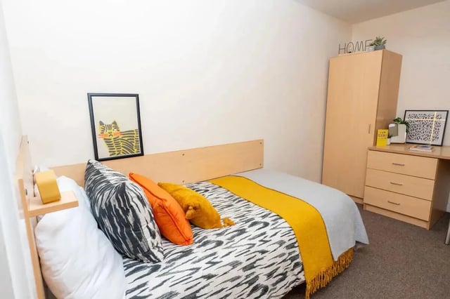 Bed with pillows dresser wardrobe desk bedroom at Grafton Street in Manchester Student Accommodation