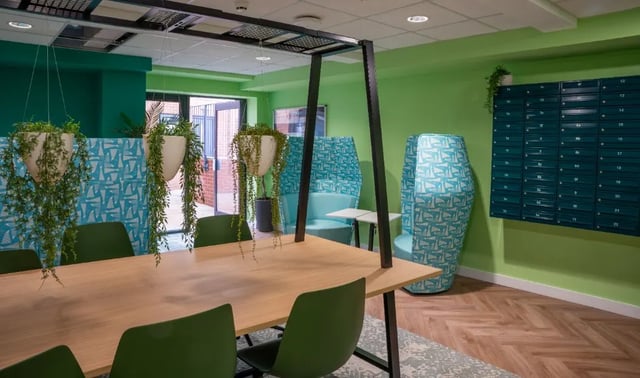 Table chairs hanging plants lounge seating communal area at Boutique Student Living - Exeter in Exeter Student Accommodation