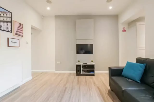 Black couch and television in living room at 51 Beresford Street in Stoke-On-Trent Student Accommodation