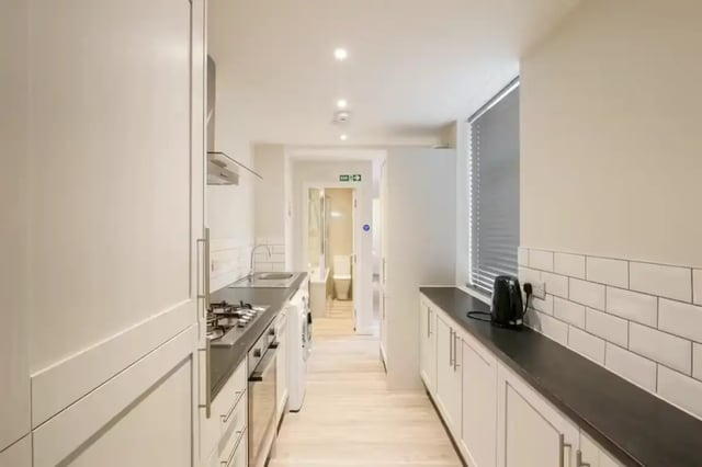 Kitchen with cabinets sink stove and washing machine at 51 Beresford Street in Stoke-On-Trent Student Accommodation