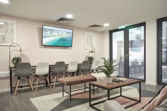Chairs bench coffee table with plants living room at The Quarry in Falmouth Student Accommodation