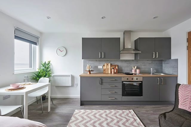Modern grey kitchen with dining table and chairs kitchen at The Quarry in Falmouth Student Accommodation