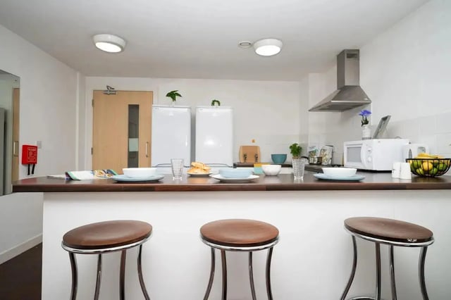 Counter with stools and kitchen appliances kitchen at Walker Street in Preston Student Accommodation