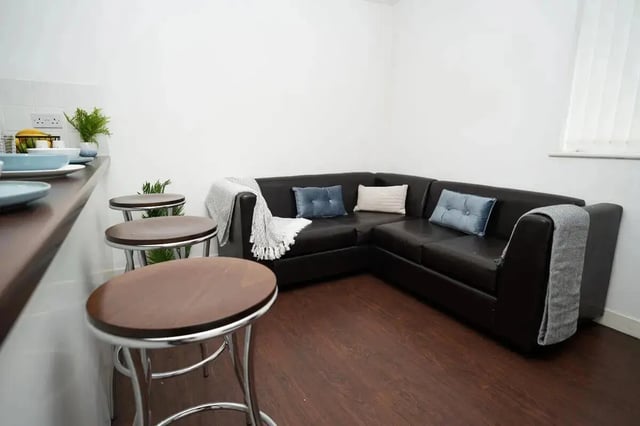 Corner sofa bar stools plant living room kitchen at Walker Street in Preston Student Accommodation