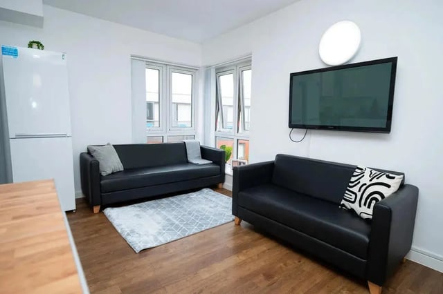 Two black sofas rug TV living room at Moor Lane Halls in Preston Student Accommodation