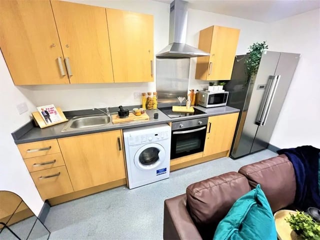 Compact kitchen with fridge oven and sofa kitchen at Parklane House in Sunderland Student Accommodation