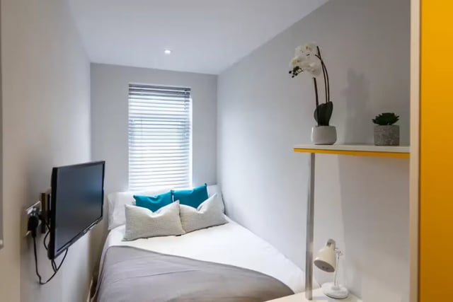 Bed with pillows TV on wall desk lamp bedroom at 38 Cauldon Road in Stoke-On-Trent Student Accommodation