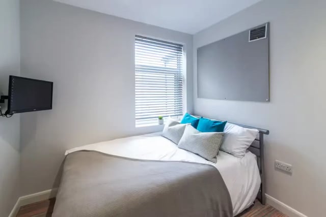 Bed with pillows tv on wall bedroom at 38 Cauldon Road in Stoke-On-Trent Student Accommodation