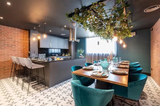 Kitchen bar dining table with teal chairs living room at Luna Hatfield in Hatfield Student Accommodation