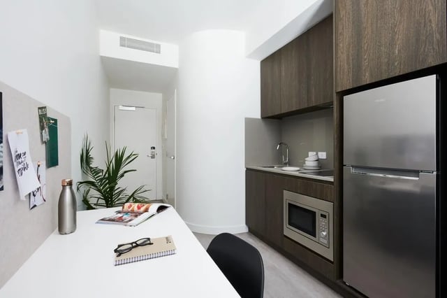 Desk with whiteboard fridge and microwave kitchen at Scape Cornell Place in Melbourne Student Accommodation