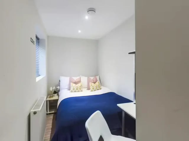 Bed with blue blanket white pillows bedroom at 86 Beresford Street in Stoke-On-Trent Student Accommodation