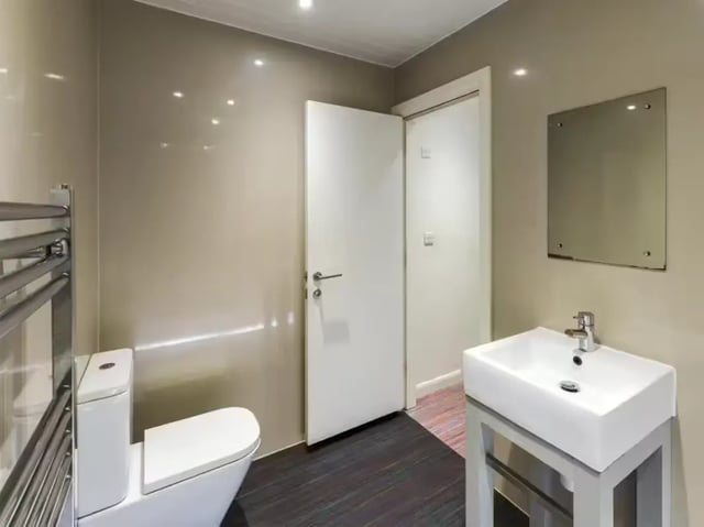 Toilet sink and mirror in clean bathroom at 86 Beresford Street in Stoke-On-Trent Student Accommodation