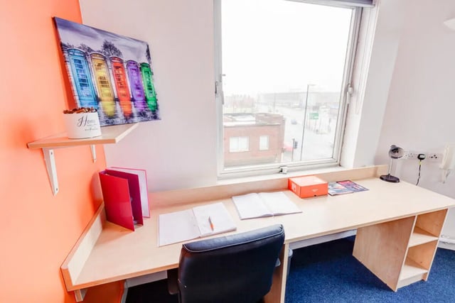 Desk with chair, books, artwork, window view study area at Dunn House in Sunderland Student Accommodation