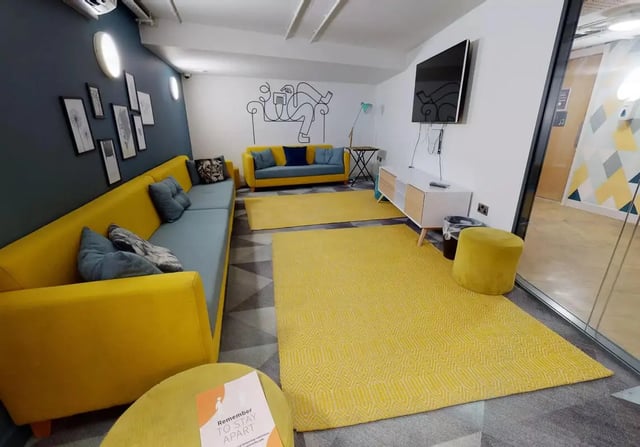 Yellow and blue sofas TV and yellow living room at iQ Bristol in Bristol Student Accommodation