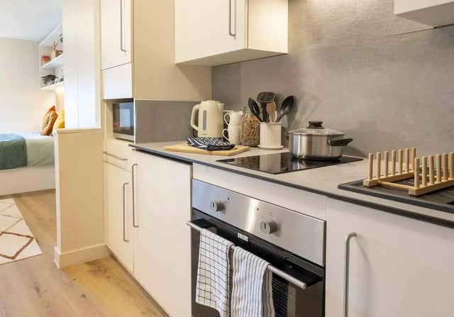 Modern kitchen with microwave oven kettle and stove kitchen at iQ Bristol in Bristol Student Accommodation