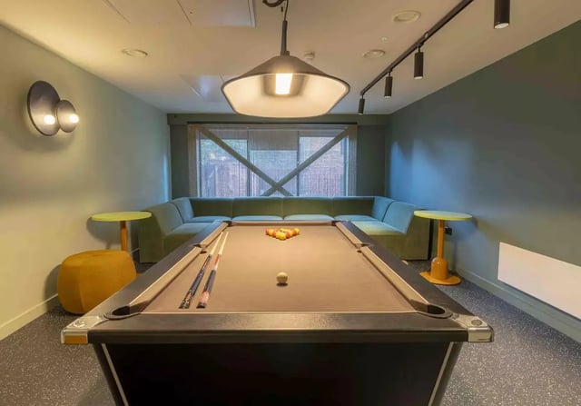 Pool table sectional sofa yellow side tables playing area at iQ Leeds in Leeds Student Accommodation