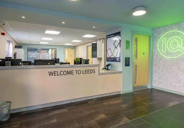 Welcome desk computers and trash can reception area at iQ Leeds in Leeds Student Accommodation