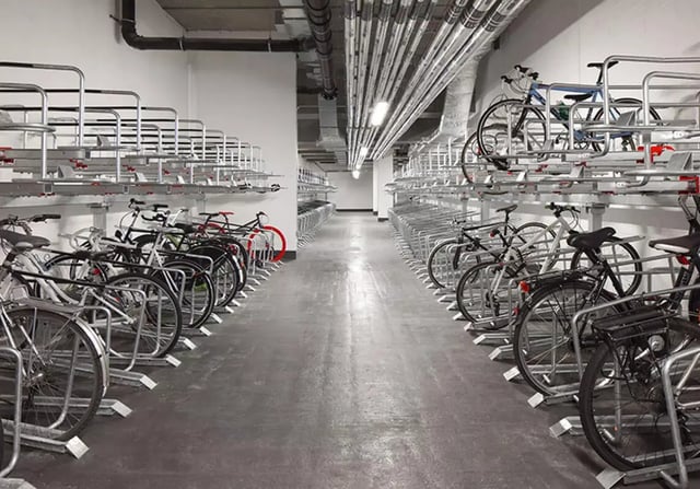 Many bicycles parked in rows bike storage exterior. at iQ Shoreditch in London Student Accommodation