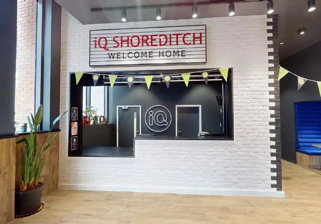 iQ Shoreditch welcome desk with flags reception area at iQ Shoreditch in London Student Accommodation