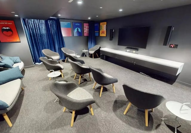 Chairs sofa TV and posters common area at iQ Shoreditch in London Student Accommodation