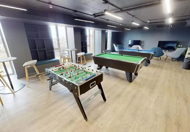 Foosball table pool tables lounge chairs recreation area at iQ Shoreditch in London Student Accommodation