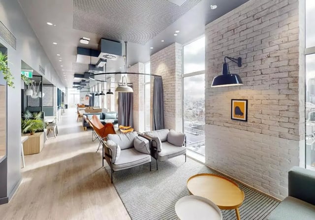 Two grey armchairs and coffee tables lounge area at iQ Shoreditch in London Student Accommodation
