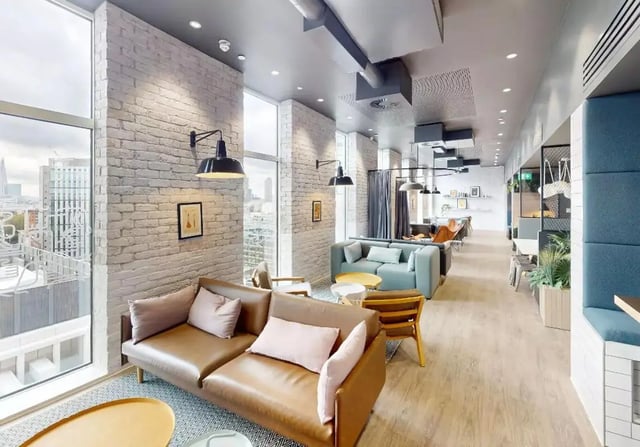 Brown leather sofa with pink cushions living room at iQ Shoreditch in London Student Accommodation