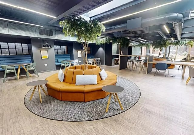 Orange circular sofa plants tables study area at iQ Shoreditch in London Student Accommodation