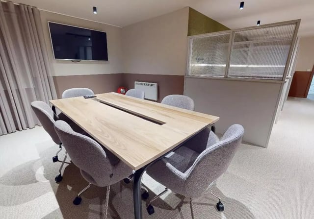 Table chairs television and partition common area at iQ Kingston in Kingston Upon Thames Student Accommodation