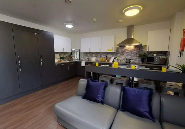Modern kitchen with grey cabinets and island kitchen at iQ Kingston in Kingston Upon Thames Student Accommodation