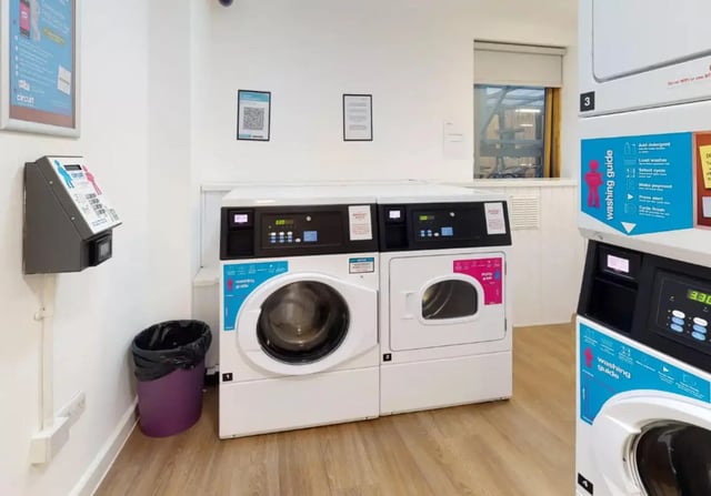 Washing machines dryers payment machine laundry room at iQ Kingston in Kingston Upon Thames Student Accommodation