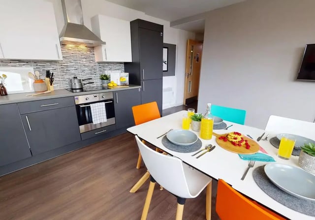 Kitchen dining table with food and chairs kitchen at iQ Kingston in Kingston Upon Thames Student Accommodation