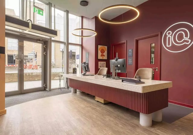 Reception desk with computers and chairs reception area at iQ Kingston in Kingston Upon Thames Student Accommodation