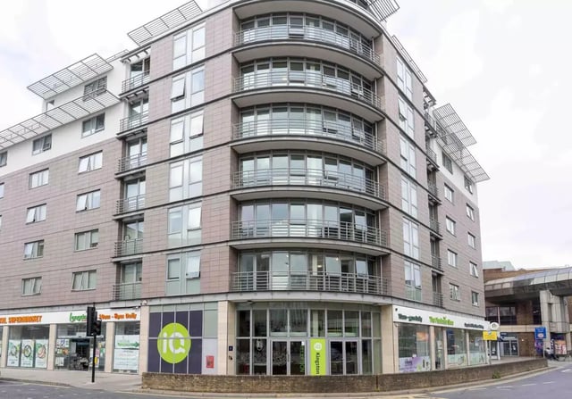 Curved building with balconies shops exterior at iQ Kingston in Kingston Upon Thames Student Accommodation