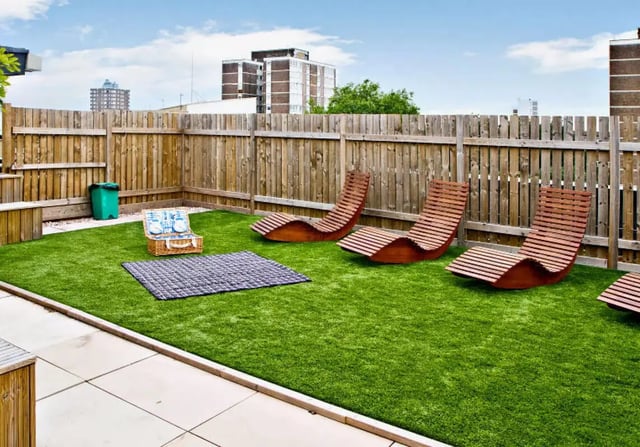 Wooden loungers picnic basket rug exterior at iQ Hoxton in London Student Accommodation