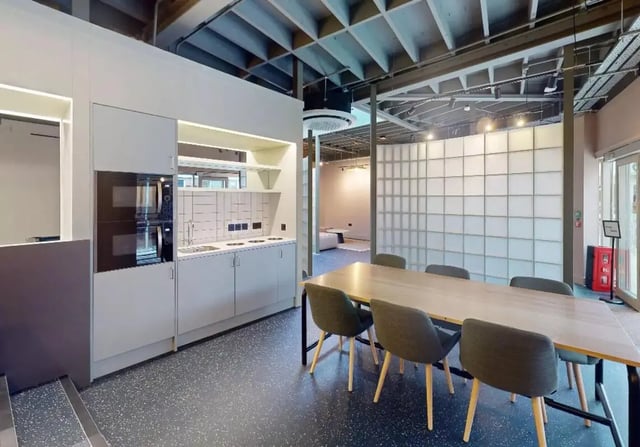 Kitchen and dining area with chairs table and appliances kitchen at iQ Hoxton in London Student Accommodation