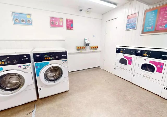 Washing machines and dryers in communal laundry room at iQ Hoxton in London Student Accommodation