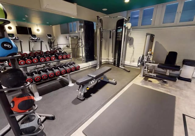 Dumbbells weight bench cable machine gym area at iQ Bloomsbury in London Student Accommodation