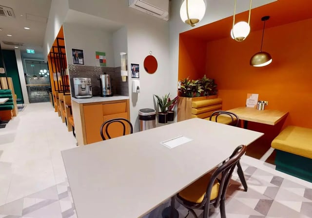 Table coffee maker chairs and dining area at iQ Bloomsbury in London Student Accommodation