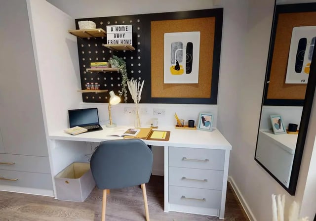 Desk with laptop chair and shelves study area at iQ Bloomsbury in London Student Accommodation