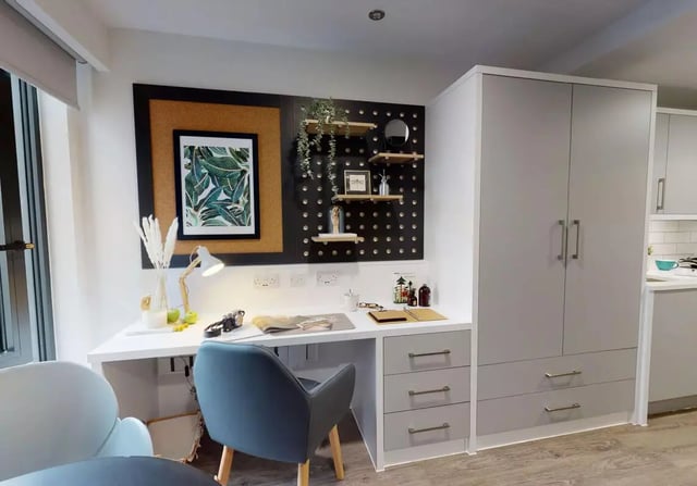 Desk cabinet chair artwork and shelves study area at iQ Bloomsbury in London Student Accommodation