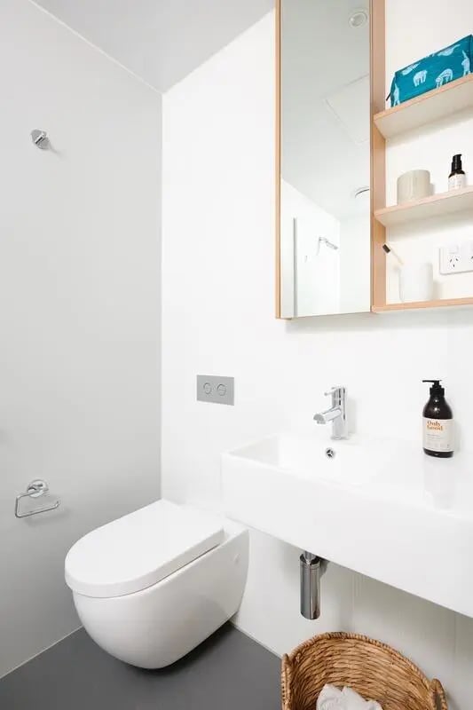 Toilet sink and mirror modern bathroom. at Scape Uni Square in Melbourne Student Accommodation